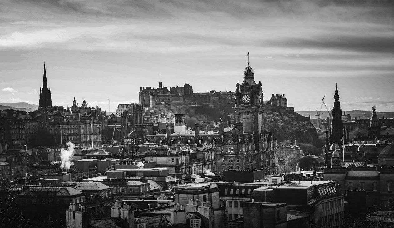 A landscape photo of Edinburgh, featuring its historic skyline and landmarks